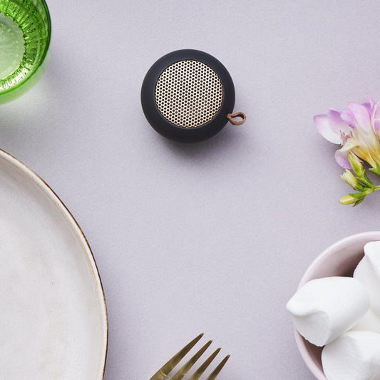 Black mini Bluetooth speaker, round with central metal speaker grille