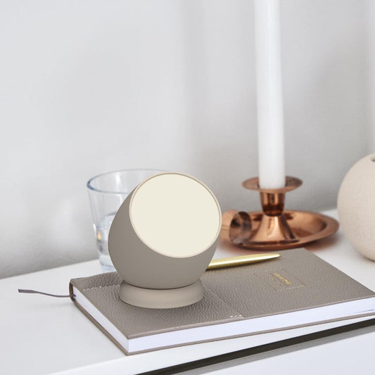 Kreafunk Beam portable rechargeable lamp in ivory sand, round shade on a tabletop