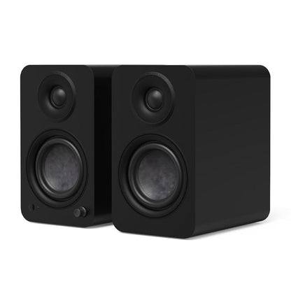 Matte black powered bookshelf speakers, front view with tweeter and woofer