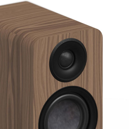 Matte walnut powered bookshelf speaker with black tweeter and woofer front grille