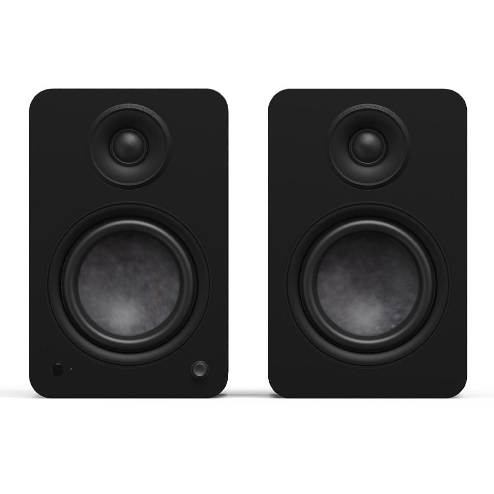 Matte black powered bookshelf speaker pair with tweeters and woofers, front view