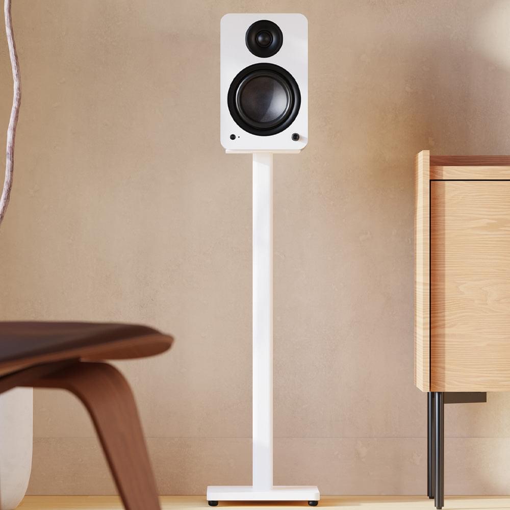 Matte white powered bookshelf speaker with black tweeter and woofer, on floor stand