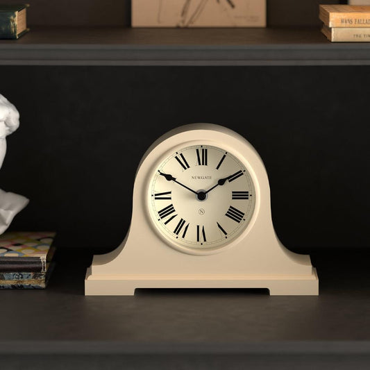 Vanilla cream mantel clock with arched case and Roman numeral face, Newgate logo