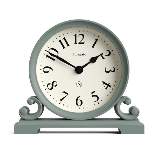 Asparagus green mantel clock with white face, black Roman numerals, and arched feet