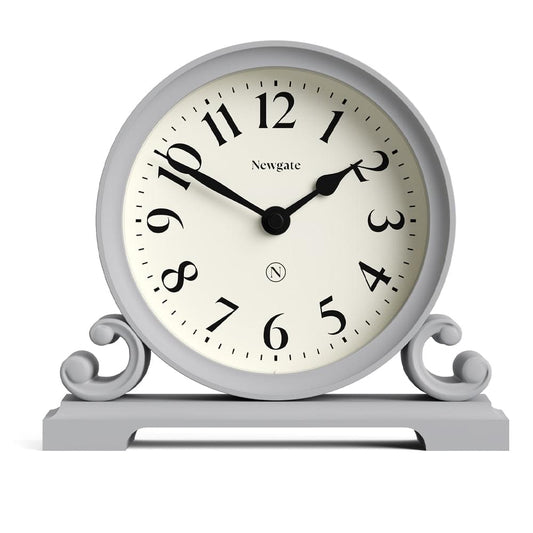 Grey mantel clock with round cream face, black hands, Newgate logo, ornate side supports