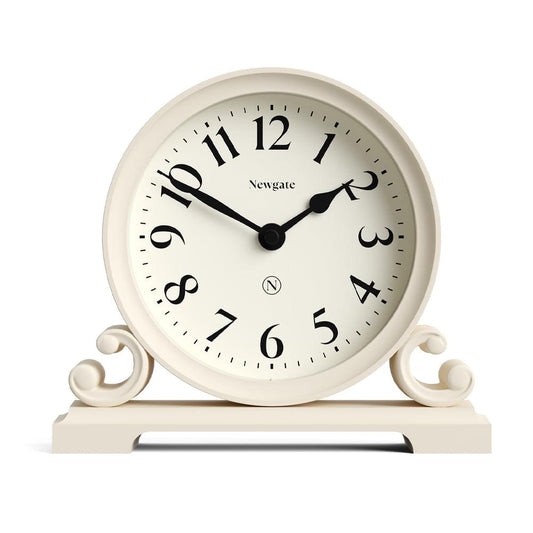 Vanilla cream mantel clock with black numerals, round face, and curved side scrolls