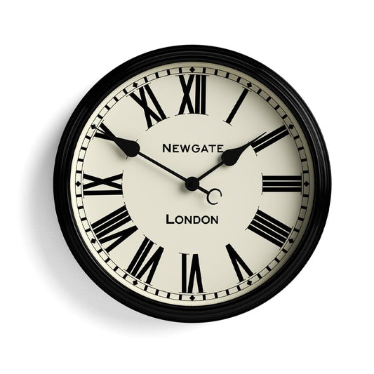 Black wall clock with Roman numeral dial, cream face and black hands