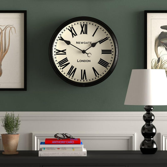 Mounted black wall clock with Roman numeral dial, cream face and NEWGATE LONDON text