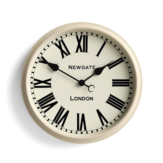 Cream wall clock close-up: black Roman numerals, Newgate logo, London text, bold hands