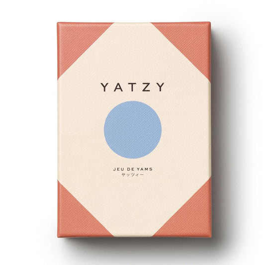 Square Yatzy game box with cream panel, blue circle logo, and orange geometric sides