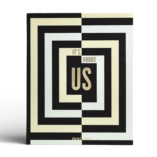Photo album with black and cream geometric cover and 'It's About Us' text
