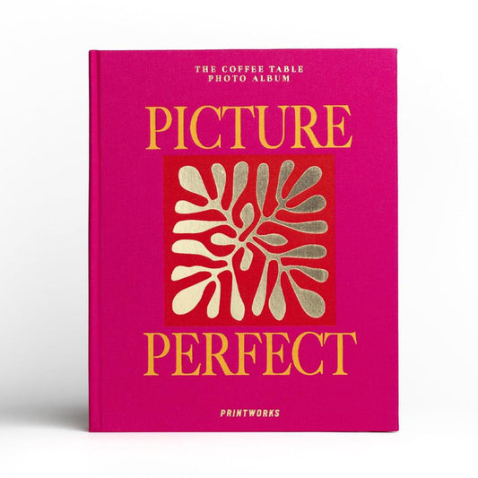 Magenta Printworks photo album with “PICTURE PERFECT” gold lettering and white floral emblem