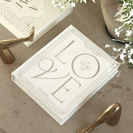 White wedding photo album with embossed “A STORY” and large “LOVE”