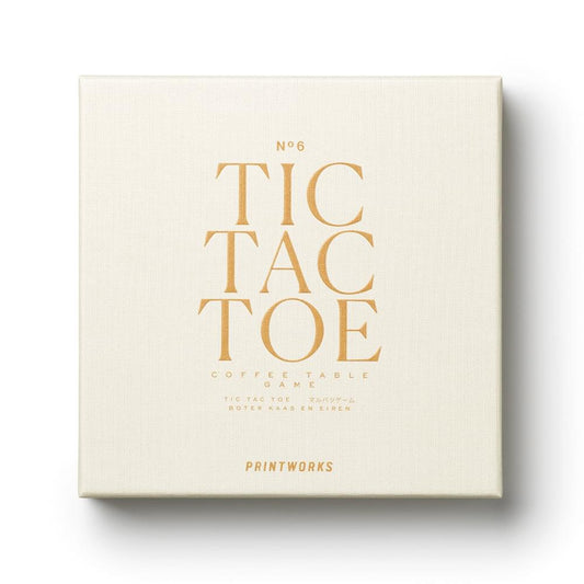 Tic tac toe game box with beige lid and gold wordmark