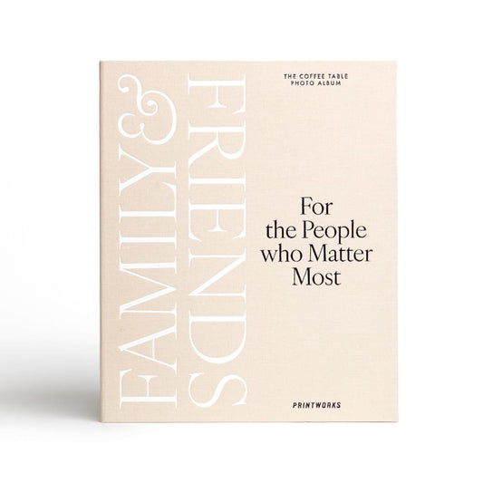 Beige photo album cover with large white FAMILY FRIENDS lettering and motto text.