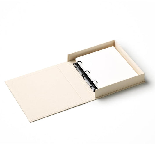 Beige open photo album with black spiral rings and blank inner pages