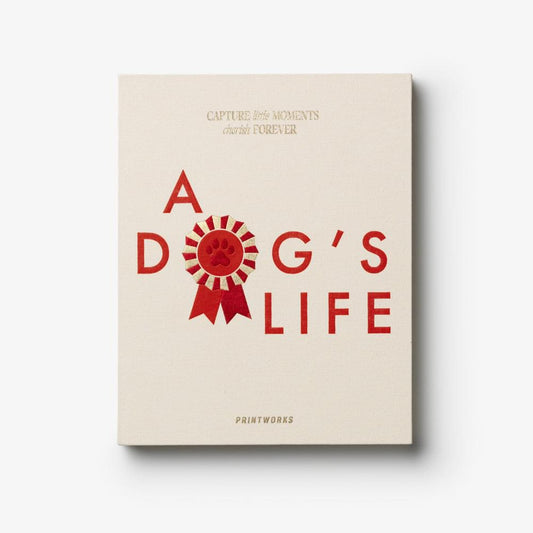Dog journal with beige cover, red ribbon badge text "A Dog's Life" and Printworks logo.
