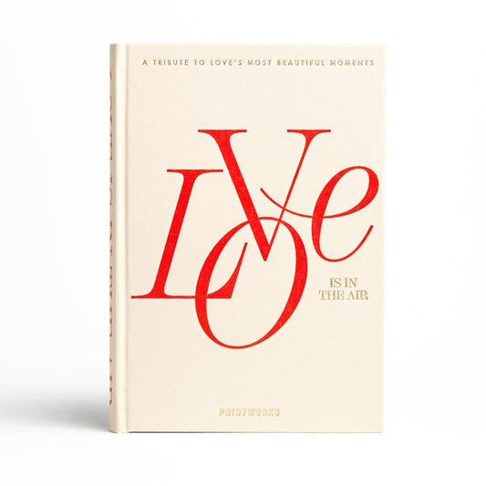 Beige photo book with red “Love is in the Air” cover design, front view
