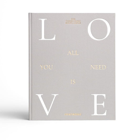 Grey photo album with typographic LOVE cover and 'All you need is love' text