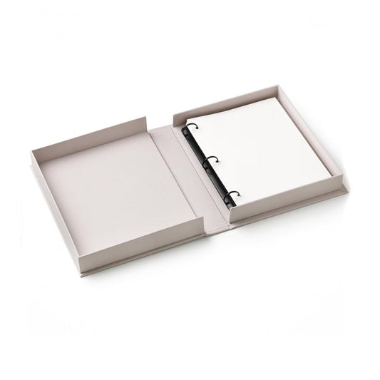 Embroidered photo album opened flat with blank pages and black ring binder.