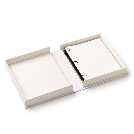 Opened photo album with white pages and black ring binder inside