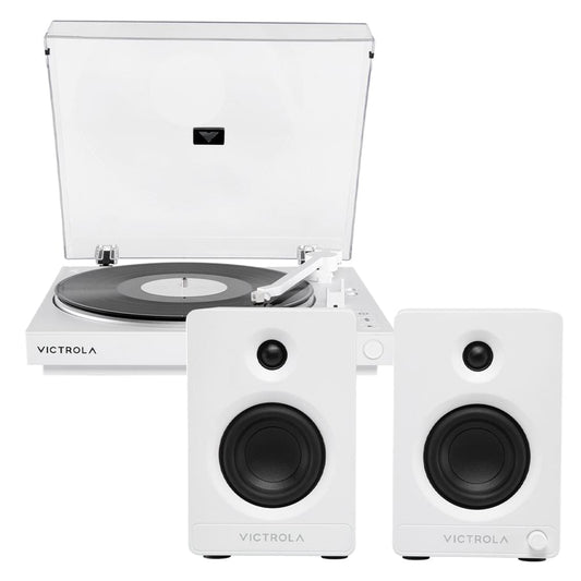 White automatic turntable with open lid and two white bookshelf speakers.