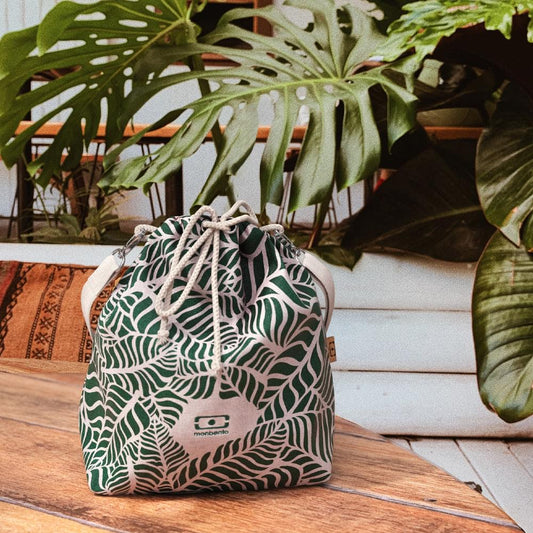 Leaf-print drawstring lunch bag with shoulder strap and monbento logo on front