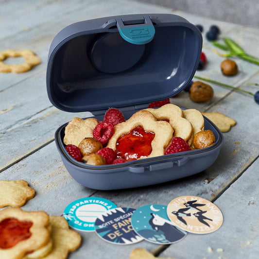 Kids snack box open with dark tray and navy lid, compartment for snacks.