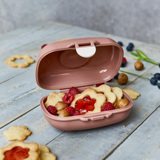 Pink kids snack box opened, showing snacks in inner compartment