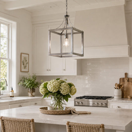 Lantern pendant light with chrome frame and glass bulb hanging over kitchen counter