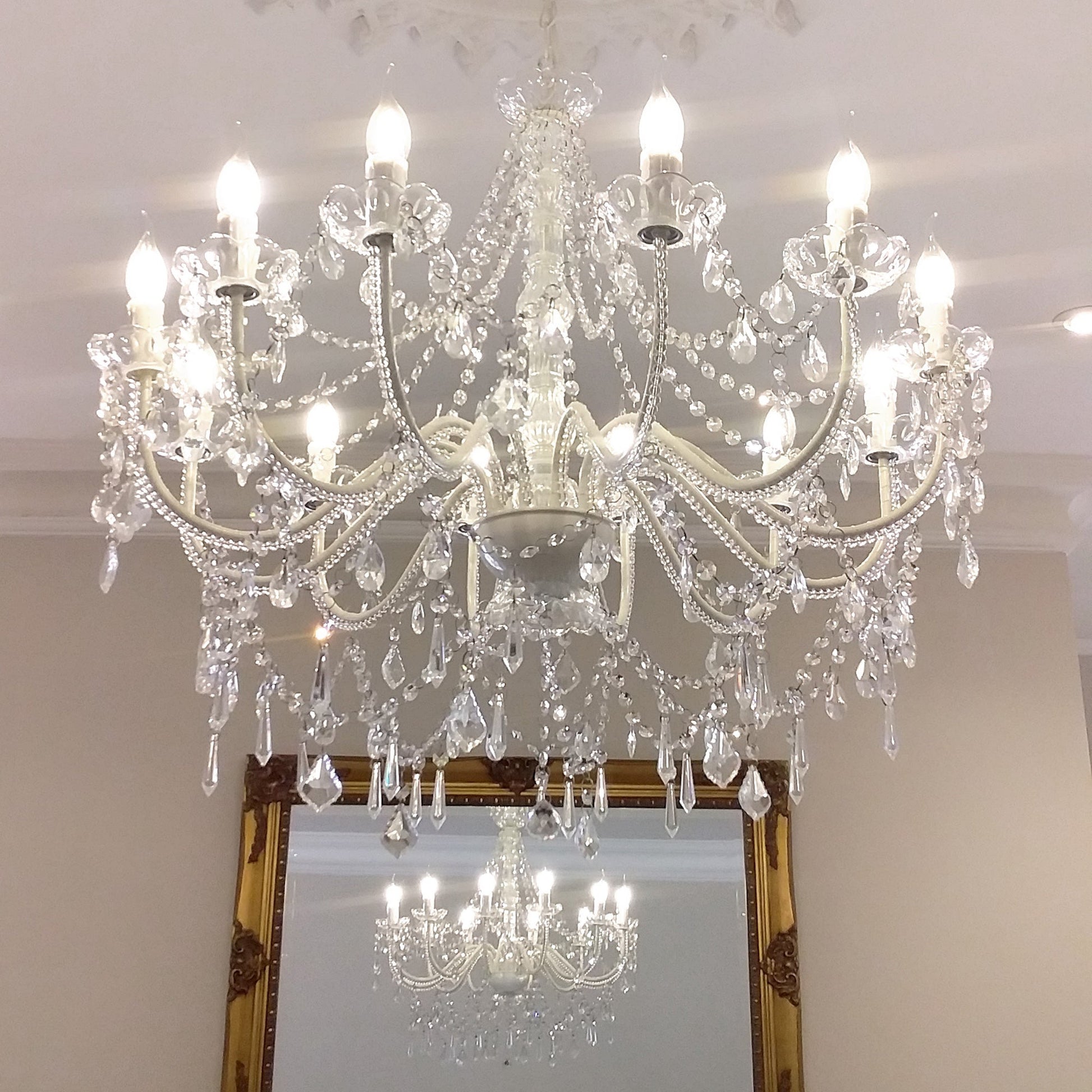 Cassie 12-light chandelier featuring clear crystal bead strands and multiple candle bulbs
