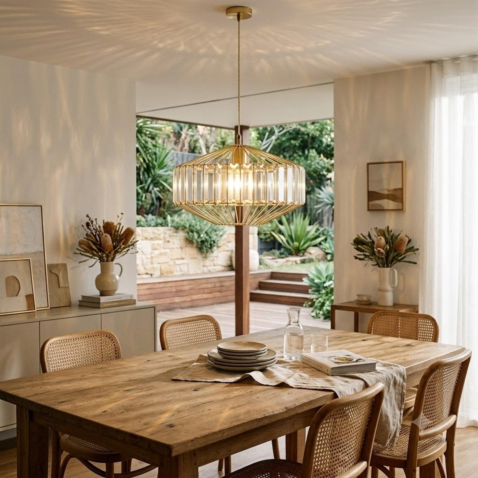 Gold prism glass pendant light, lit interior, faceted clear glass shade