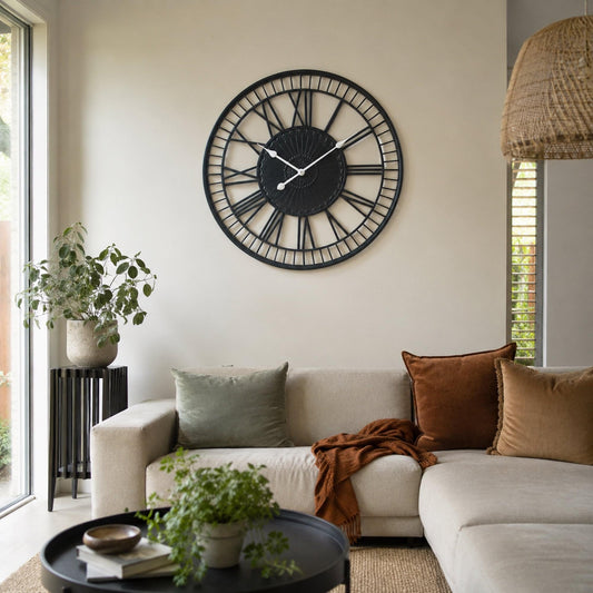 Charcoal metal wall clock with black roman-style hour markers and white hands