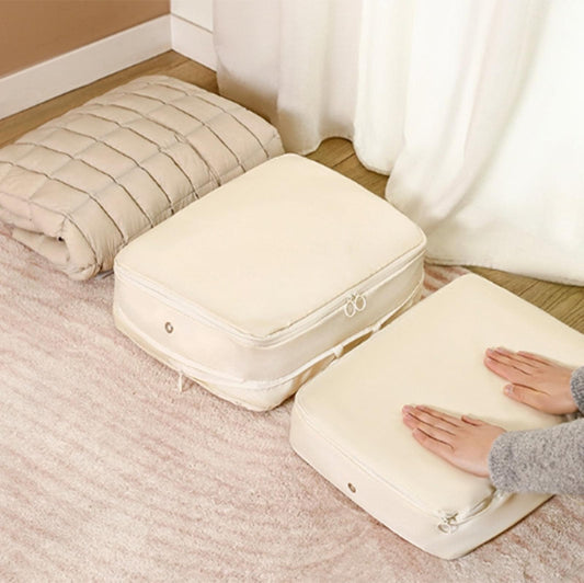 Set of cream compression storage bags with zippers on bedroom carpet