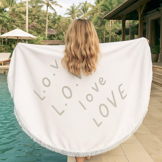 Round white beach towel with fringed edge and gray love letter print