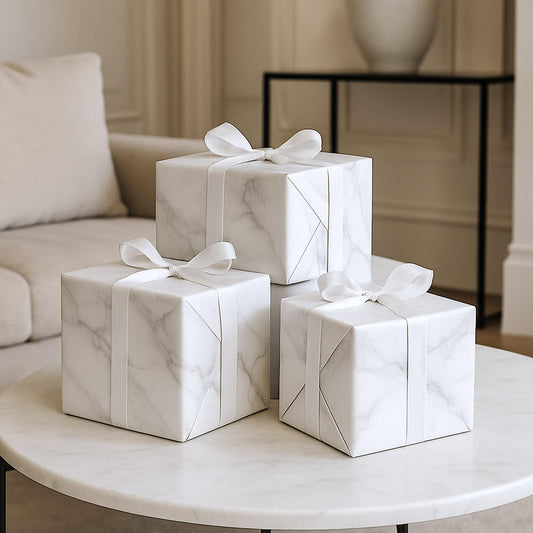 Marble-pattern wrapping paper with white wrapped gift boxes and ribbon bows