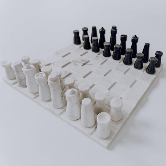Marble-look chess board with white and dark gray pieces, top view