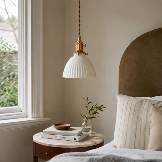 Ceramic pleated pendant light with white pleated shade and brass socket on cord