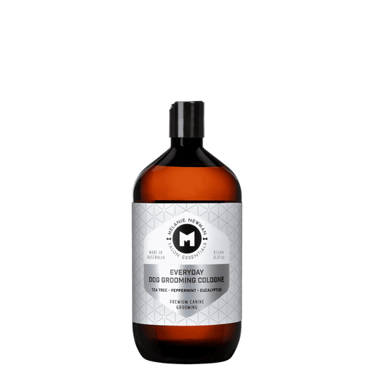 Everyday dog grooming cologne bottle with black cap, amber-orange glass