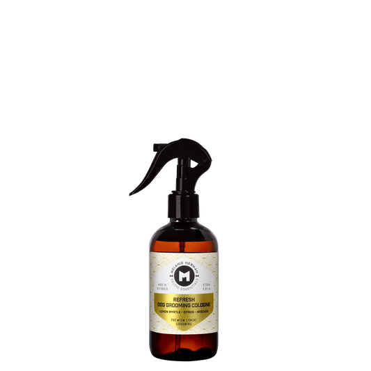 Dog grooming cologne spray bottle with black trigger, amber liquid