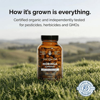 Organic moringa capsules bottle in grass with certified organic badge