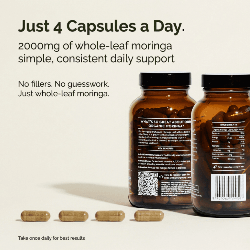 Moringa capsules supplement bottles with loose capsules on a surface