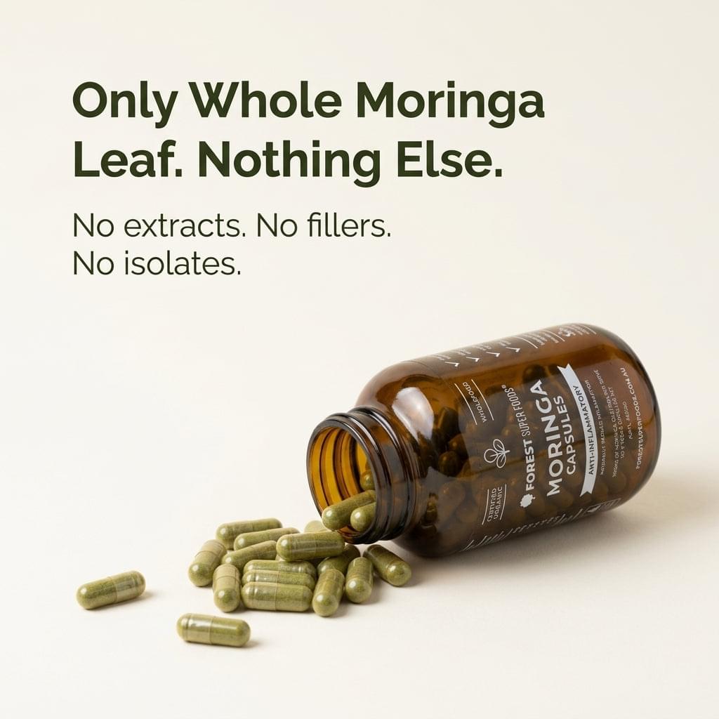 Moringa capsules bottle with scattered capsules and leaf fragments
