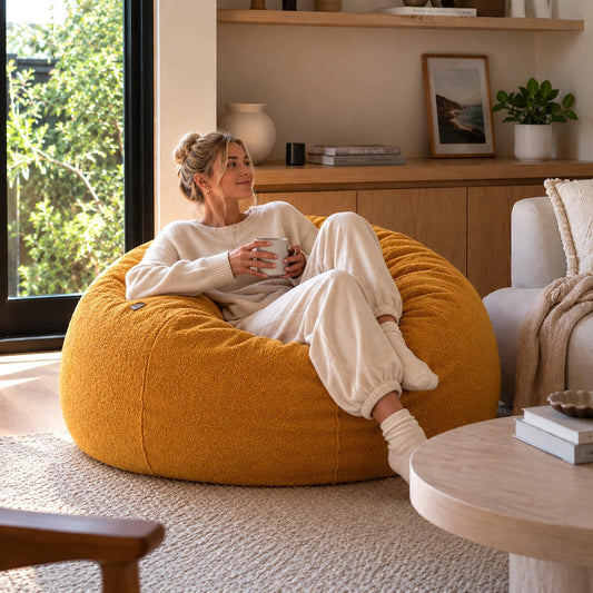 Mustard boucle bean bag with adult relaxing, side view