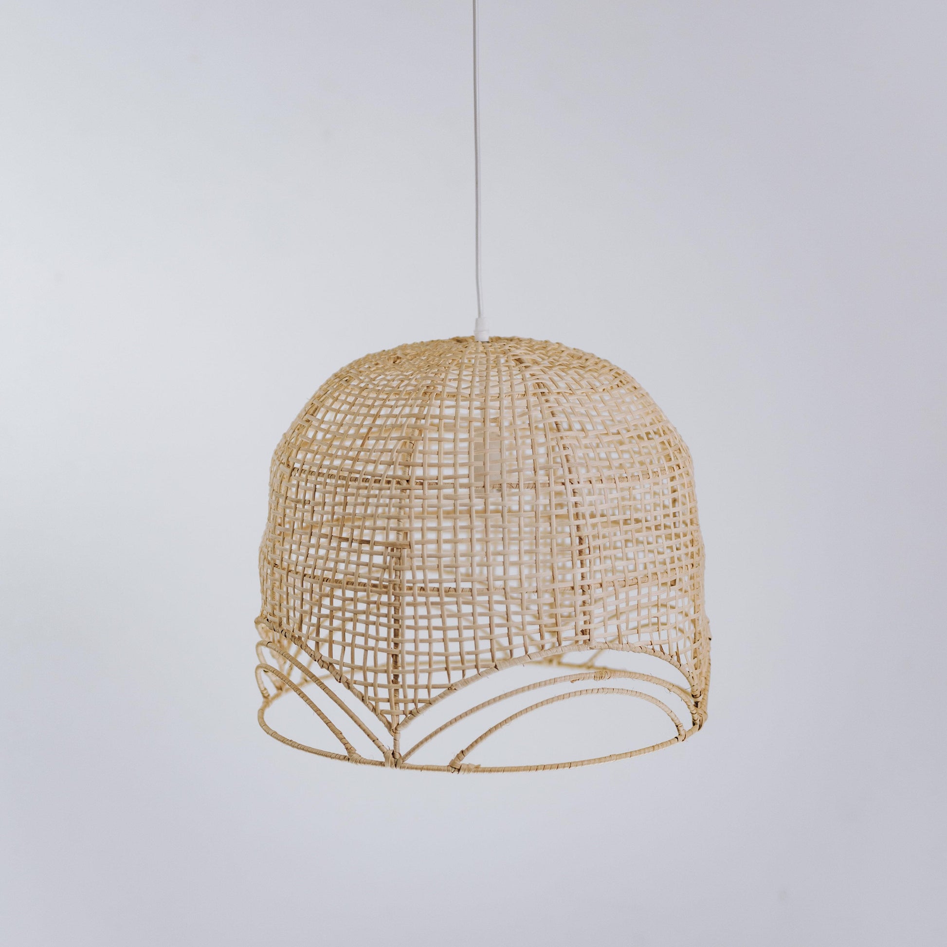 Natural rattan pendant light with domed woven shade and scalloped white-trim edge