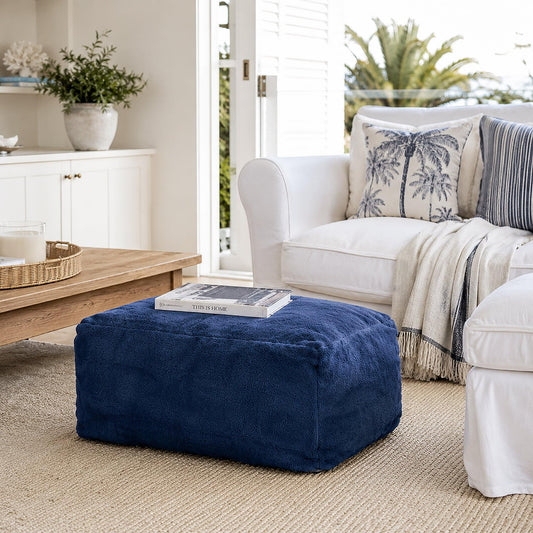Navy blue plush upholstered ottoman, low rectangular shape