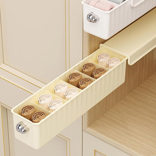 Long wall-mounted storage organizer with multiple slots for rolled underwear items