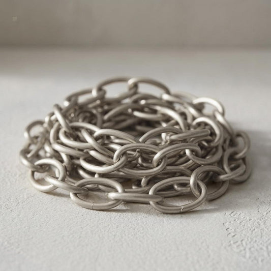 Brushed nickel chain extension coiled with interlocking oval links