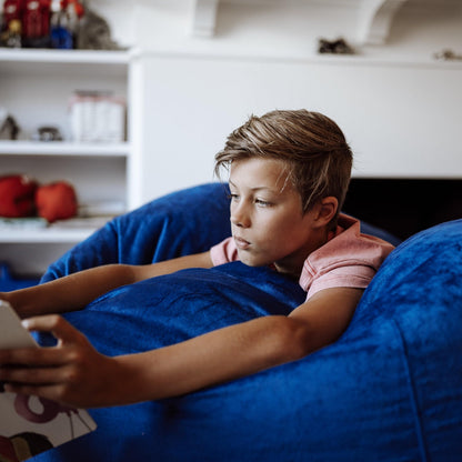 Ocean blue fur-style bean bag, child lounging