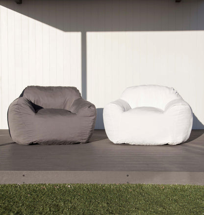 Outdoor bean bag chair set on patio: charcoal grey and white rounded seats